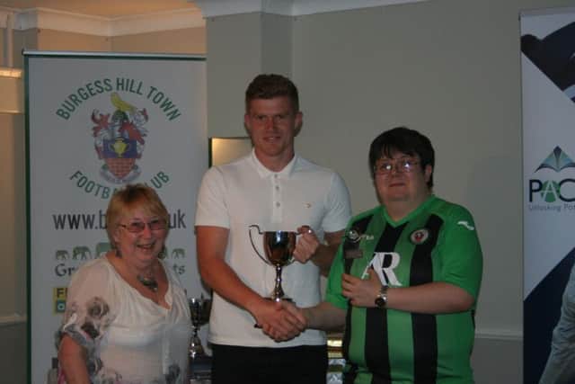 Josh James receiving his Malcolm Stephens Supporters Player of the Year award from Terri and Joe Stephens