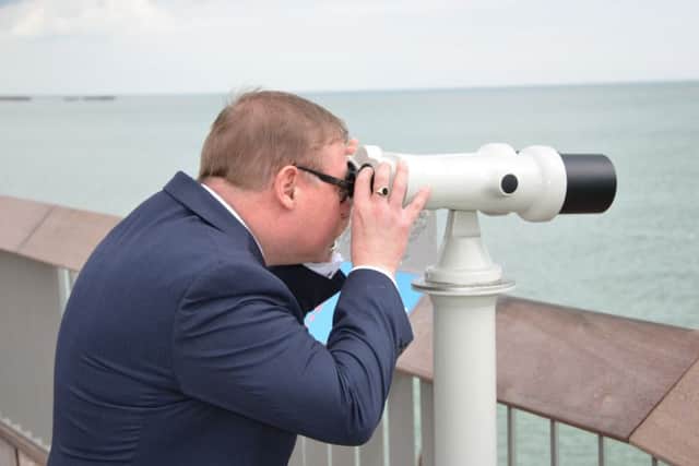 Mark Francois having a go with the pier telescopes.  Photo by Sid Saunders