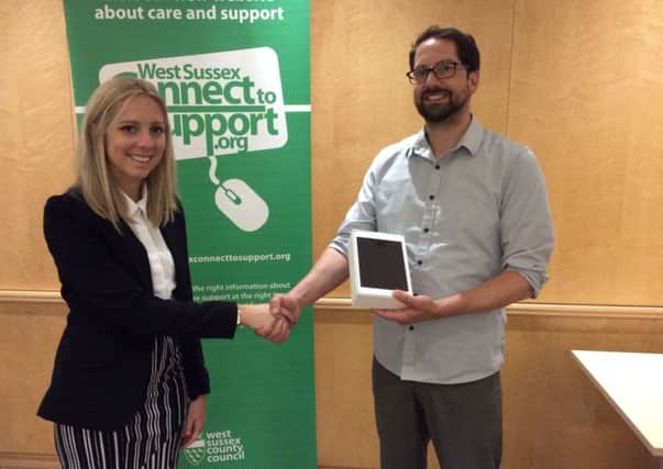 Laura Power from PCG Solutions presents the iPad to Martin Stean on behalf of the Hollyrood Centre in Lindfield. SUS-160525-093723001