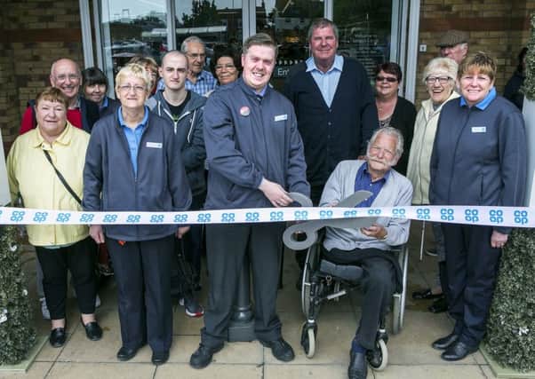 Manger Chris Fallion cuts the ribbon with Bernie Stevens ( Selsey First Responders)  (right) with staff and public Opening of Coop in Selsey, West Sussex Picture:  David McHugh