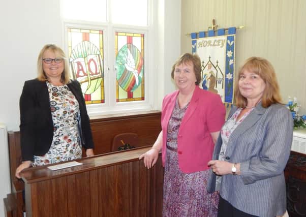 Stained glass windows are installed at St Francis Church in Horley in memory of former church warden John Lochead. Pictured are his wife Penny (centre) with artists Heather Roll and Sharon Price - picture by Mark Dunford