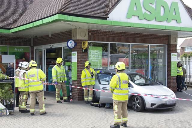 Car reverses into supermarket window