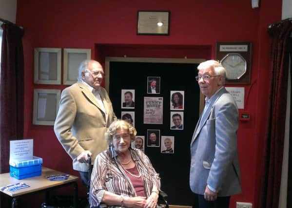 Betty Dawes, beneath the plaque installed in 2014, with her husband, Ralph, left, and association secretary Dave Comber