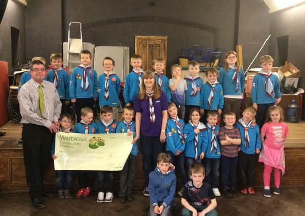 Daren Bakers from Waitrose presents Gill Marriott and the 2nd Goring Beavers with their cheque