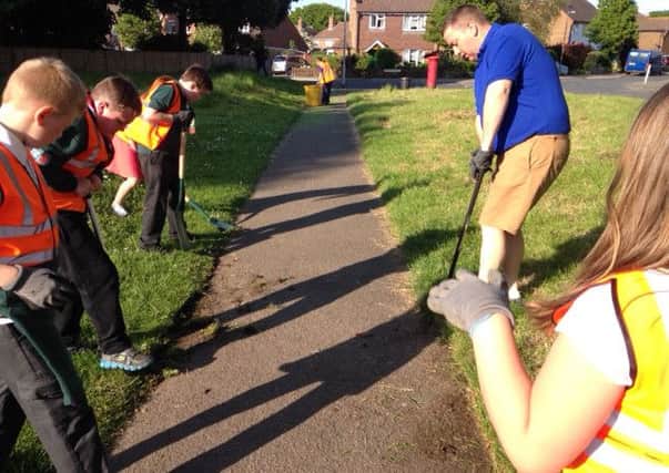 Scouts from 1st Sidley All Saints help clean up the recreation ground