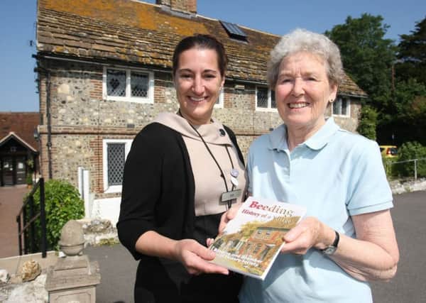 Pat Nightingale, right, hands a copy of the new edition to ZoÃ« Bates, owner of Valerie Manor care home. Photo: Derek Martin DM16122463a