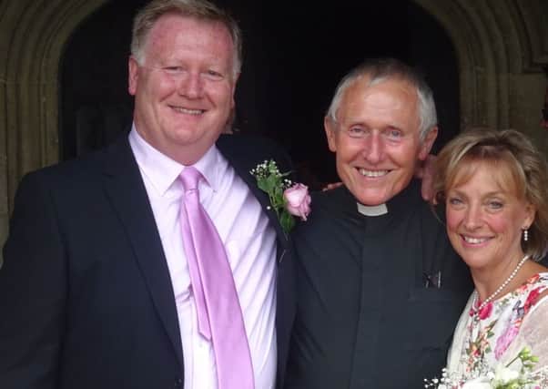 Andrew and Julie McDonnell on their wedding day with  Fr John Lee SUS-160614-124324001