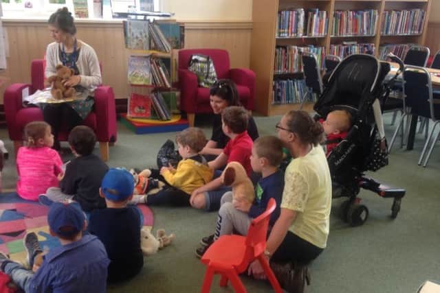 Families listening to stories during the teddy bears' picnic