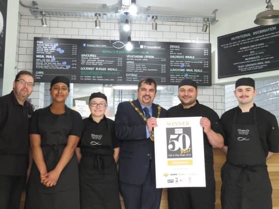 Owner of Athena's Fish and Chip Shop, Nick Damurakis, holding the award with Bexhill mayor Simon Elford, manager Tom Finlay, delivery driver Tim, and servers Hannah and Jada SUS-160906-122622001