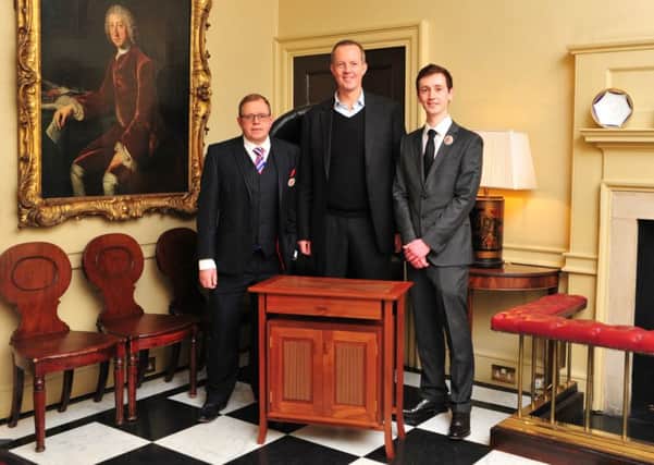 Edward Harringman (right) presents his gold medal winning cabinet to Skills Minister Nick Boles (centre) at 10 Downing Street. They are joined by Christian Notley (left), a lecturer at Chichester College and a WorldSkills UK Expert for Cabinet Making.