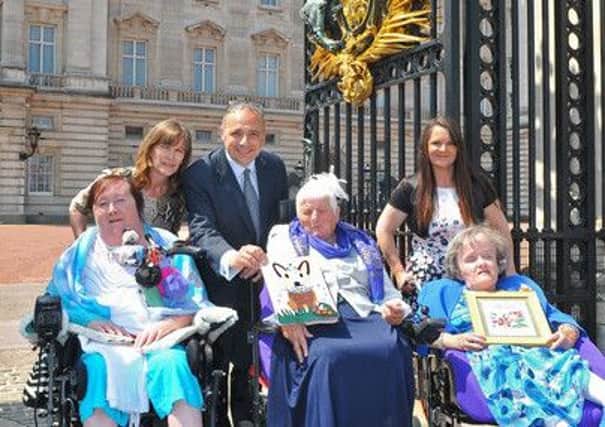 Hand delivering birthday cards and gifts to The Queen for her 90th birthday (L-R) Sandra Bedwell and Jane Lightfoot from Copthorne, Queen's Chief Clerk Christopher Sandamas, Janet Peters, Alison Beadle and Darleen Jonson from County Durham