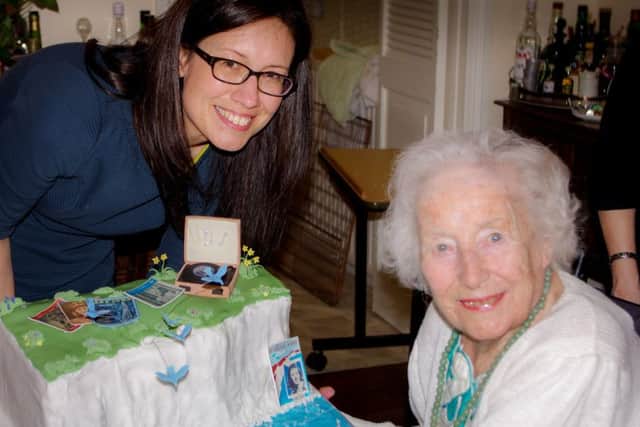 Dame Vera Lynn on her 99th birthday with Mia Taggart, who made the cake. SUS-160321-150054001