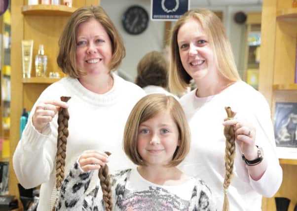 Robyn Preece with her mum Helen Preece and auntie Katherine Lester following their hair cuts for the Little Princess Trust