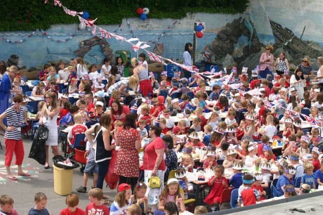 Pupils at Cradle Hill School in Seaford celebrating the Queen's 90th birthday with a special lunch in the playground - Picture by Ron Hill