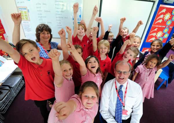 Headteacher Christopher Todd and pupiils at Singleton Primary School celebrate their good Ofsted rating