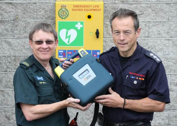 A defibrillator has been installed outside Worthing Fire Station. Tim Gray from SECAmb, which provided the equipment, is pictured with station manager Roy Barraclough. Photo: Eddie Mitchell