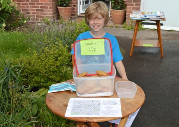 Isaac Penny, nine, with his cookie stall