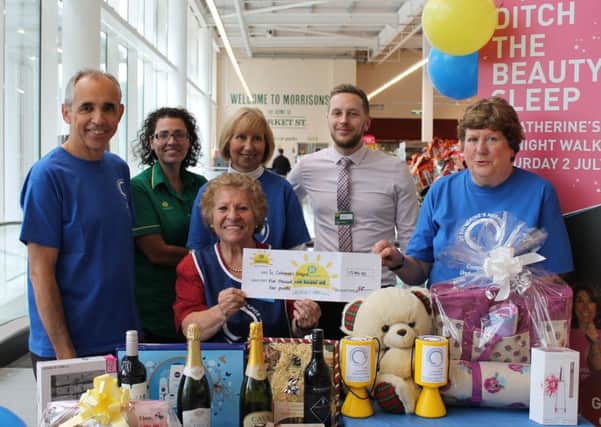 Staff at the Morrisons store in Crawley donate Â£5,904 to St Catherines Hospice through the companys  charitable arm, the  Morrisons Foundation - submitted