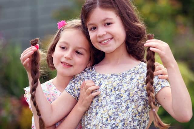 Six year old Lilly donated her hair to charity in support of her sister Francesca, nine. Photo by Derek Martin. SUS-160627-221637008