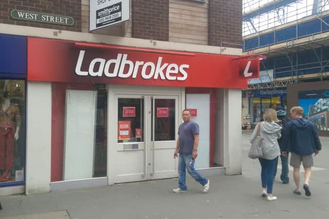 Signs go up in Ladbrokes in West Street announcing the store has closed.