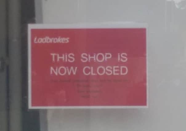 Sign announcing Ladbrokes closure in West Street.
