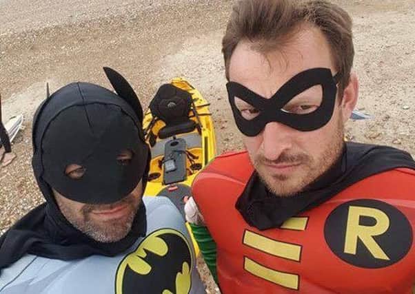 Superhero 'selfie'. Derren Guile (Batman) and David Schneider (Robin) on the beach after rescuing the kite surfer