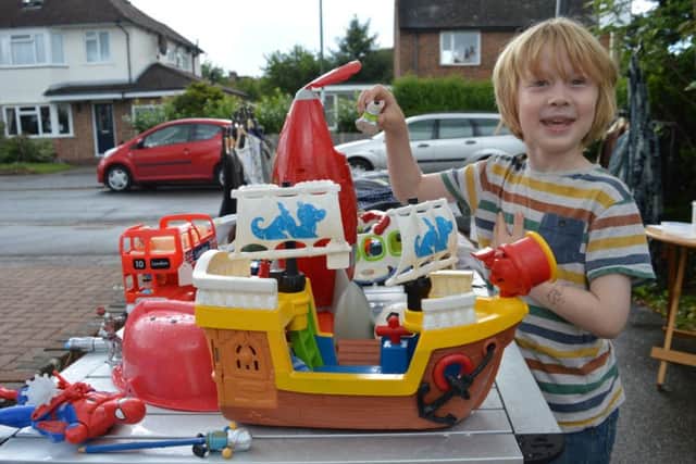 Otto Penny, five, with his toy stall in Cedar Drive