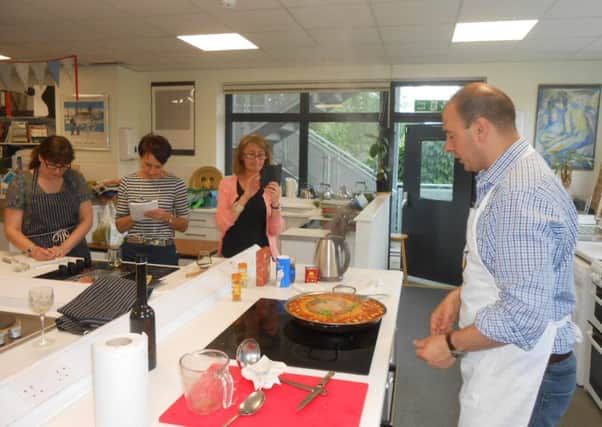 Adult students enjoy learning  how to make paella at Collyer's