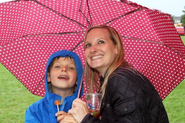 Staying dry, Sophie Witherden and her son Charlie, six, DM16126475a