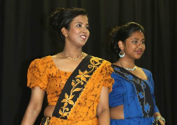 International Neighbours Day multicultural festival in Shoreham. Sandani Wickramasinghe left and Dohara De Silva who run Binuz Boutique in Shoreham and put on a fashion show. Photo by Derek Martin SUS-160625-201932008