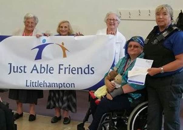 Littlehampton Police have donated Â£300 to the Just Able Friends charity. Picture: Sussex Police