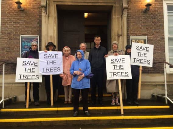 Worthing Society supporters gathered outside the town hall on Wednesday in protest against the felling of three sycamore trees as part of the Montague Centre plans SUS-160107-145006001