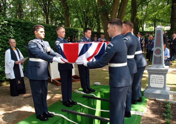 The RAF Queens Colour Squadron lowering the coffin
