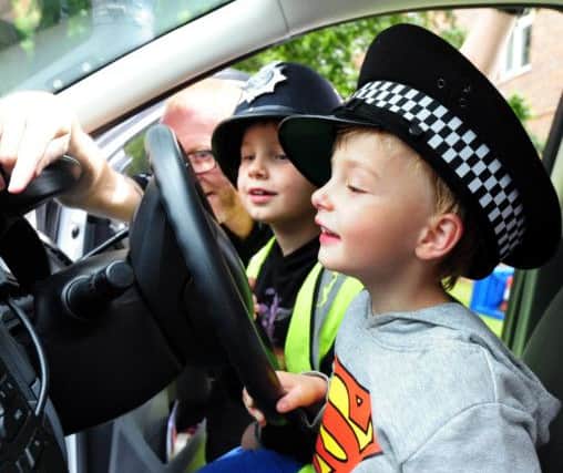 ks16000798-3 Chi Charles Av Event  phot kate

Sgt Craig Wilkie showing Danny Paice, four and his brother Charlie, seven, the inside of a police car..ks16000798-3 SUS-160307-130706008
