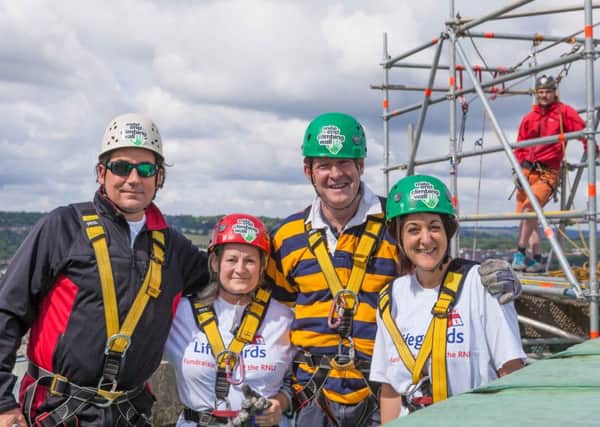 Headmaster Michael Wilson and parents of Cranleigh Prep School abseiling Guildford Cathedral