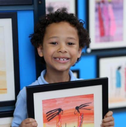 Milo Dean, seven, with his pastel picture of the Massai people DM16129685a