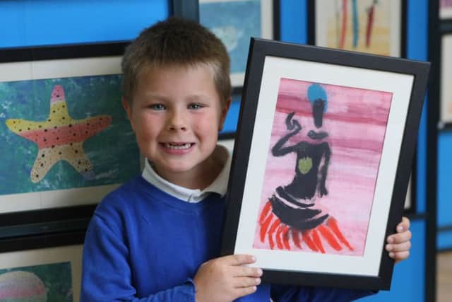Year-two pupil Flynn Power, seven, with his Wild About Africa artwork DM16129667a