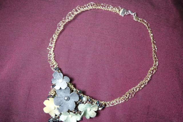 A floral necklace by Jill Mills