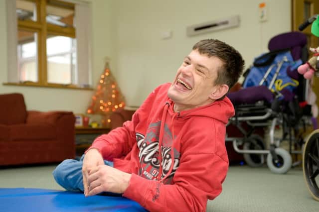 A Mary House resident enjoys time out of his wheelchair. SUS-160718-133800001