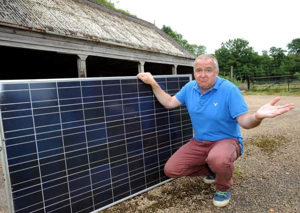 Andy Leslie with one of the solar panels that have been mysteriously removed from their roof while they were away. Pic Steve Robards  SR169897 SUS-160807-152345001