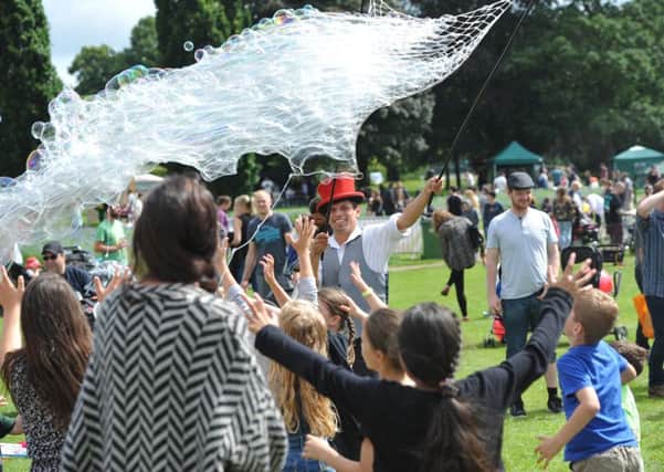 SC1676850 Sunday 10th July, Horsham Park.  Sparks In The Park 2016. Bubblejo of Flamingfun.com gives children chance to chase bubbles.  Photo credit Steve Cobb HDC