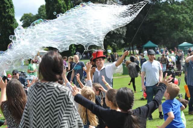 SC1676850 Sunday 10th July, Horsham Park.  Sparks In The Park 2016. Bubblejo of Flamingfun.com gives children chance to chase bubbles.  Photo credit Steve Cobb HDC