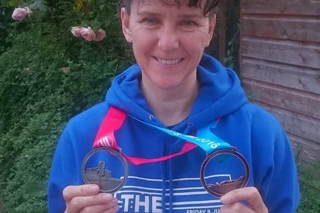 Rose Ryan in Tenby with her Long Course Swim & Bike Medals