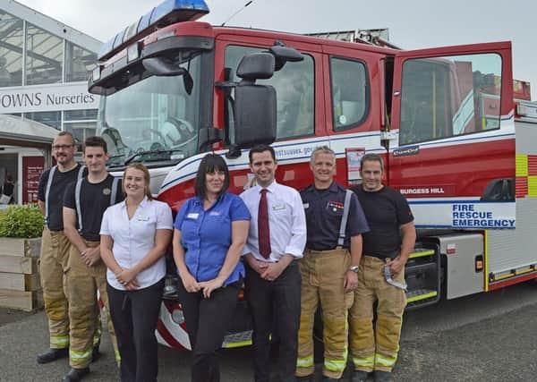 Members of the Burgess Hill Fire and Rescue Service pose in front of their truck with South Downs Nurseries Staff.