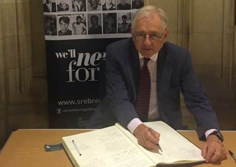 Sir Peter Bottomley signing the Srebrenica Memorial Day Book