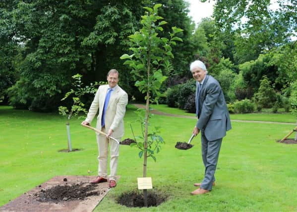 Harry Goring, owner of Wiston House and Richard Burge, Chief Executive, Wilton Park planting the tree