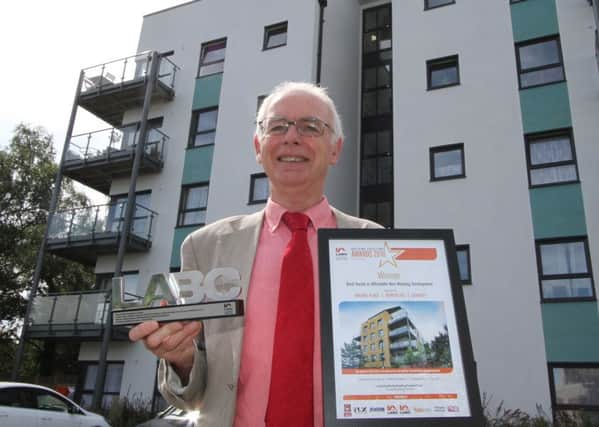Crawley Borough Council cabinet member for economic development Peter Smith with the LABC award for the Brunel Place development in Northgate - submitted