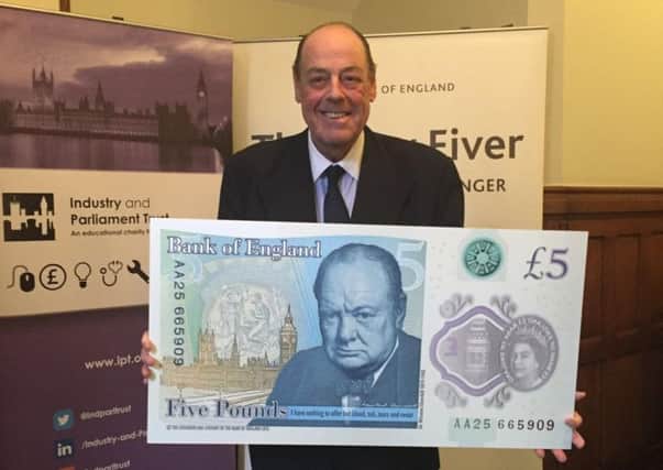 Mid Sussex MP Sir Nicholas Soames with the new Â£5 note depicting his grandfather Sir Winston Churchill SUS-160714-145047001