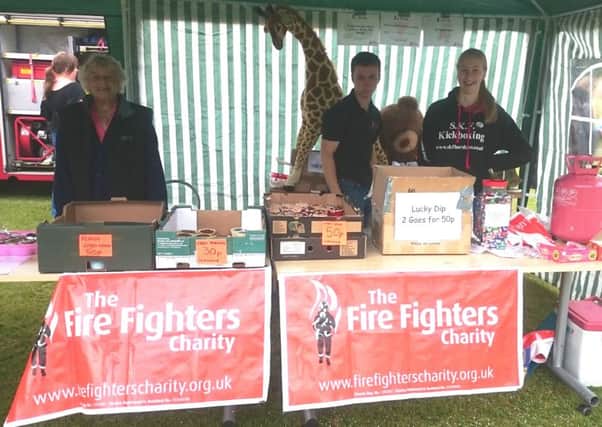 Horsham firefighter Laura Fitch and her family raise money for the Firefighters Charity at the Horsham Sparks in the Park 2016 - submitted