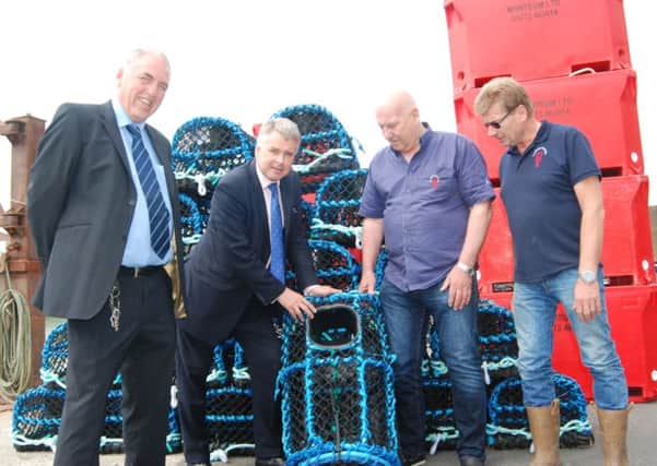 John Malone, Tim Loughton, Jim Partridge and Chris Huxtable looking at one of the lobster pots made in Lewes Prison. PICTURE: JOHN PERIAM